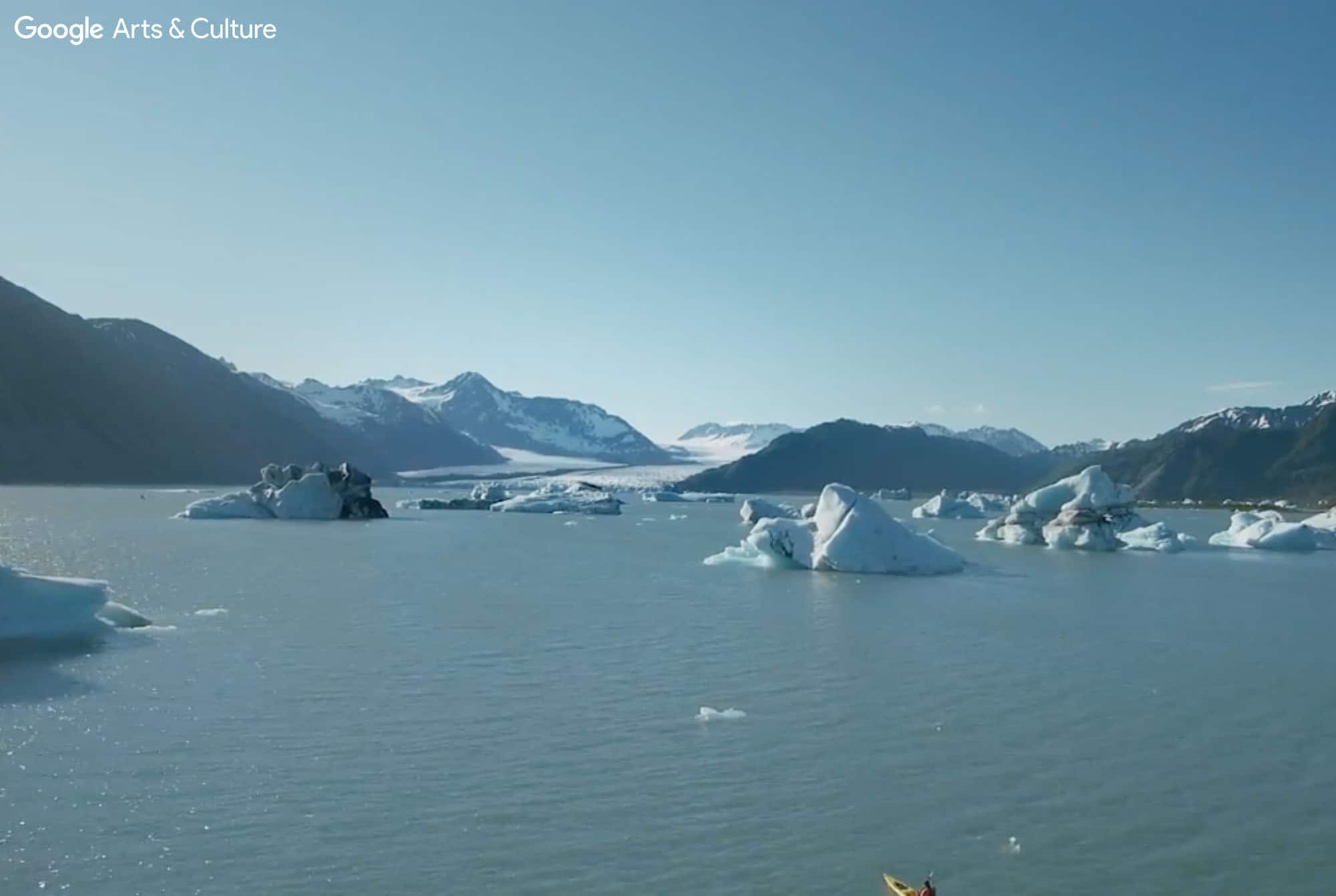 A picture of snowy mountains over a body of water