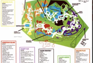 A classic theme park map divided into zones such as County Fair, Yukon Territory, and Orleans Place. Each section is color-coded and features labeled attractions, rides, shows, and amenities.